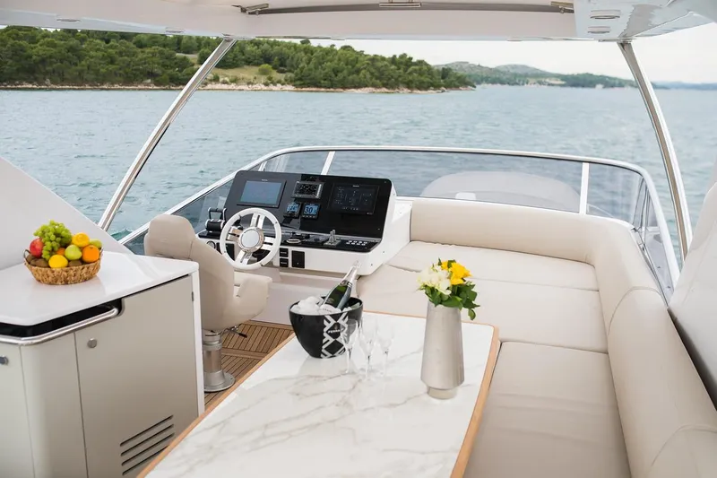 Mawi Yacht Photos Pics Luxurious 2019 Azimut FLY 55 yacht interior with helm, seating, and fruit basket.