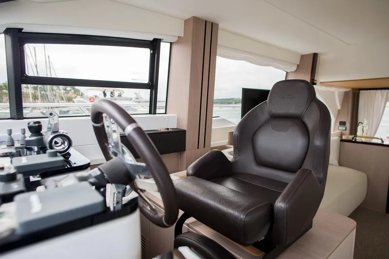 Mawi Yacht Photos Pics Luxurious interior of 2019 Azimut FLY 55 yacht with leather captain's chair.