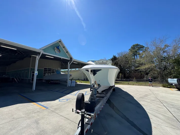  Yacht Photos Pics 2019 Fountain 39 NX boat on trailer outside a building under clear blue sky.