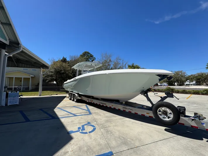  Yacht Photos Pics 2019 Fountain 39 NX boat on trailer in sunny outdoor setting.