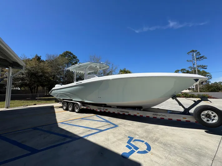  Yacht Photos Pics 2019 Fountain 39 NX boat on trailer in parking lot under clear blue sky.