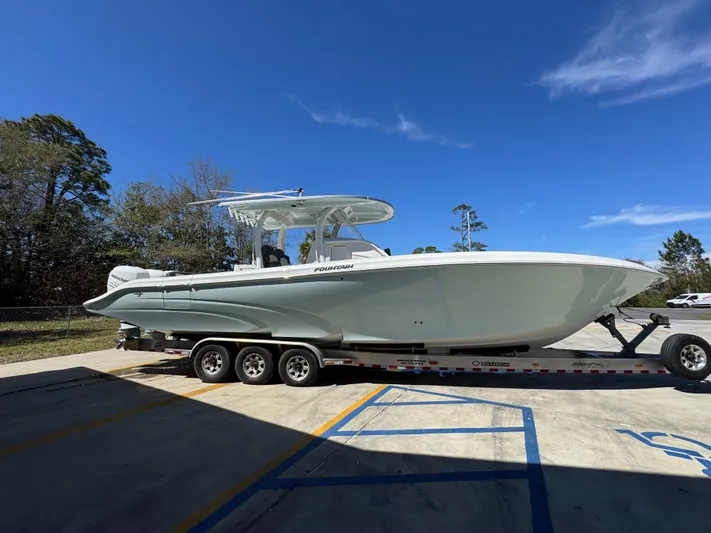  Yacht Photos Pics 2019 Fountain 39 NX boat on trailer, parked outdoors under clear blue sky.