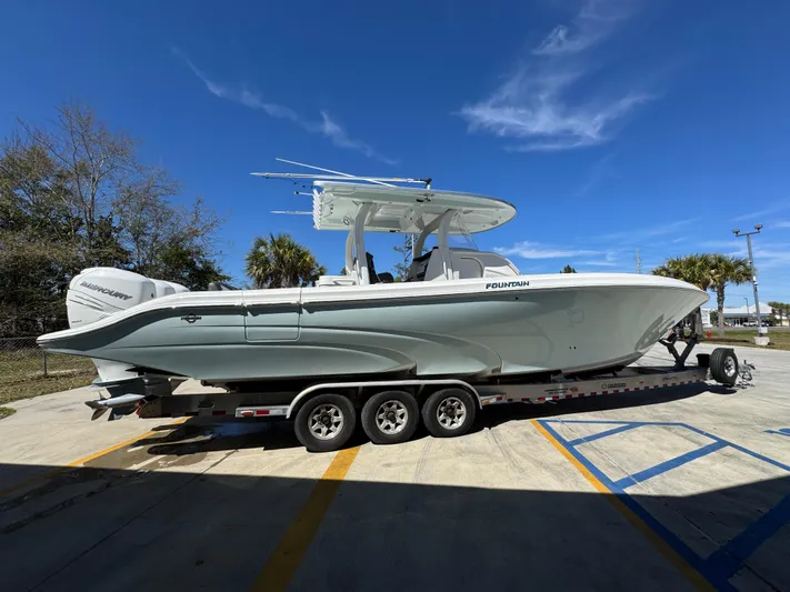  Yacht Photos Pics 2019 Fountain 39 NX boat on trailer, parked outdoors under clear blue sky.