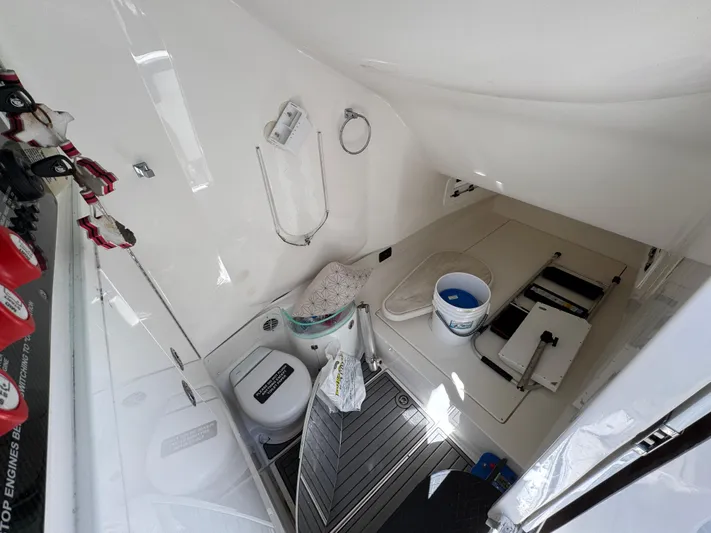  Yacht Photos Pics 2019 Fountain 39 NX boat interior with toilet, shower, and storage area.