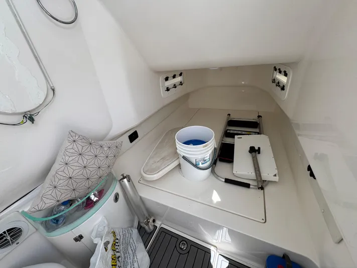  Yacht Photos Pics 2019 Fountain 39 NX boat interior with storage, bucket, and pillow.