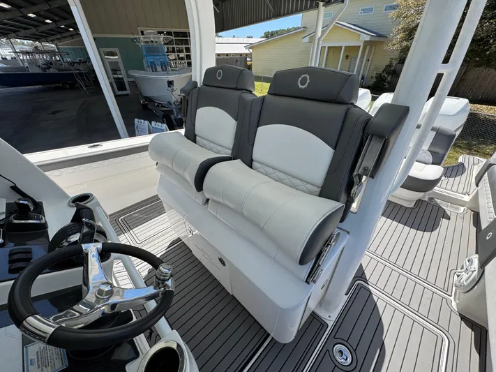 Yacht Photos Pics 2019 Fountain 39 NX boat interior with dual cushioned seats and steering wheel.