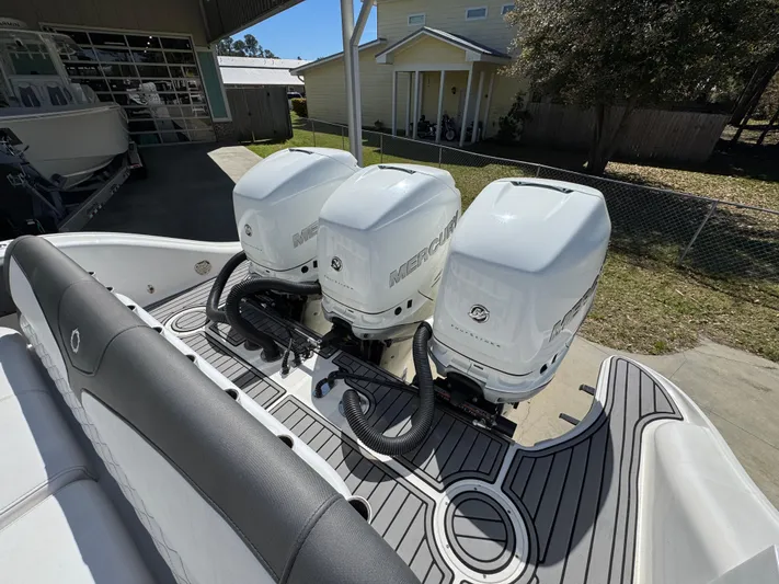  Yacht Photos Pics 2019 Fountain 39 NX boat with triple Mercury outboard engines in a driveway setting.