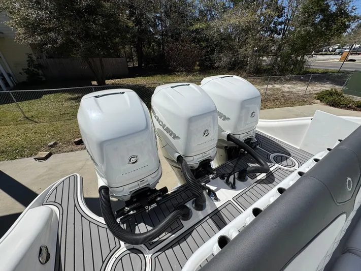  Yacht Photos Pics 2019 Fountain 39 NX boat with triple outboard engines, docked outdoors.