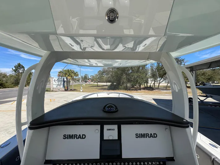  Yacht Photos Pics 2019 Fountain 39 NX boat dashboard with dual Simrad displays, under a clear blue sky.