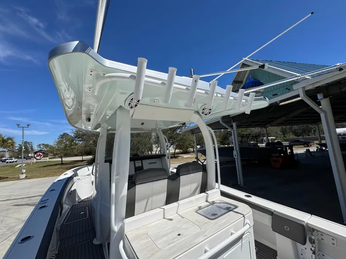  Yacht Photos Pics 2019 Fountain 39 NX boat with seating and rod holders, docked under a clear blue sky.