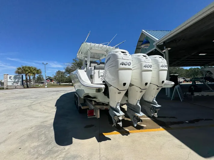  Yacht Photos Pics 2019 Fountain 39 NX boat with triple 400 horsepower engines in a sunny outdoor setting.