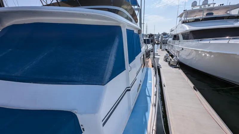 Guadalupe Yacht Photos Pics 1989 Ditmar & Donaldson Custom Cruiser docked beside luxury yachts.