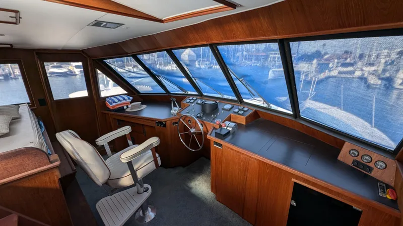Guadalupe Yacht Photos Pics Interior of 1989 Ditmar & Donaldson Custom Cruiser boat with wooden helm and panoramic windows.