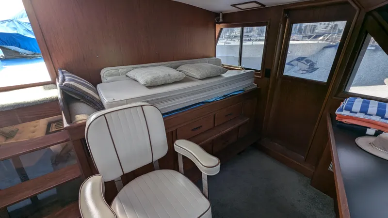 Guadalupe Yacht Photos Pics 1989 Ditmar & Donaldson Custom Cruiser interior with bed, chair, and windows.