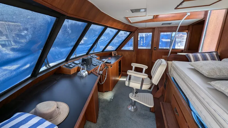 Guadalupe Yacht Photos Pics Interior of 1989 Ditmar & Donaldson Custom Cruiser with helm, seating, and nautical decor.