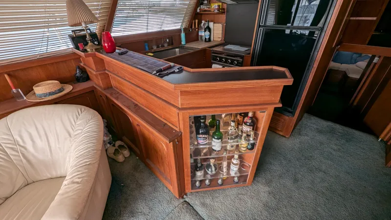 Guadalupe Yacht Photos Pics 1989 Ditmar & Donaldson Custom Cruiser interior with wooden bar and liquor display.