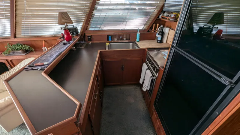 Guadalupe Yacht Photos Pics 1989 Ditmar & Donaldson Custom Cruiser kitchen with wood cabinetry and modern appliances.