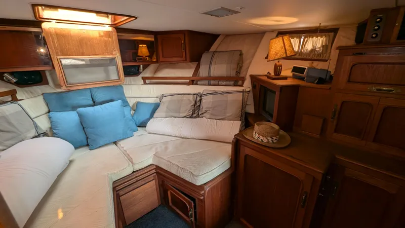 Guadalupe Yacht Photos Pics 1989 Ditmar & Donaldson Custom Cruiser interior with cozy seating and wooden cabinetry.
