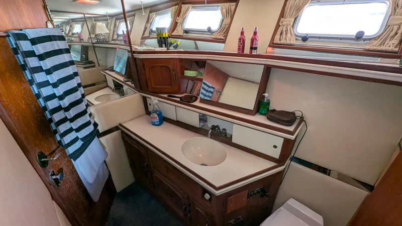 Guadalupe Yacht Photos Pics 1989 Ditmar & Donaldson Custom Cruiser bathroom with sink, mirrors, and nautical decor.