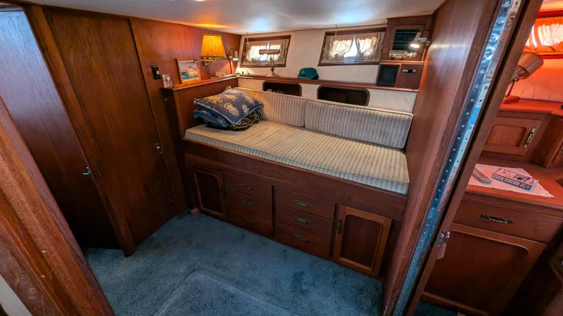 Guadalupe Yacht Photos Pics 1989 Ditmar & Donaldson Custom Cruiser cabin with wooden interior and cozy seating area.