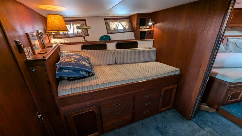 Guadalupe Yacht Photos Pics Cozy 1989 Ditmar & Donaldson Custom Cruiser cabin with wooden interior and cushioned seating.