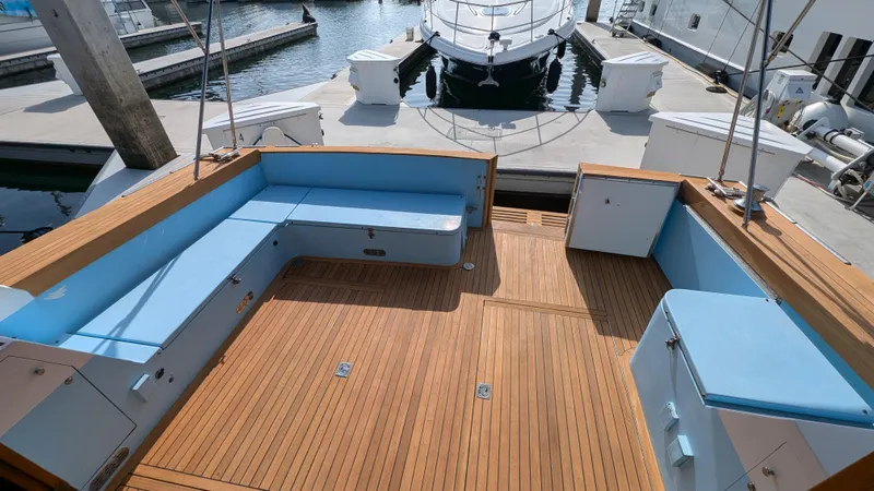 Guadalupe Yacht Photos Pics 1989 Ditmar & Donaldson Custom Cruiser with teak deck and blue seating at marina.