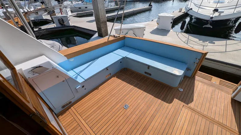 Guadalupe Yacht Photos Pics 1989 Ditmar & Donaldson Custom Cruiser with teak deck and blue seating at marina.