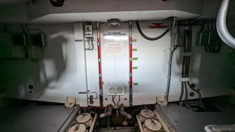 Guadalupe Yacht Photos Pics Engine room of 1989 Ditmar & Donaldson Custom Cruiser with visible pipes and controls.