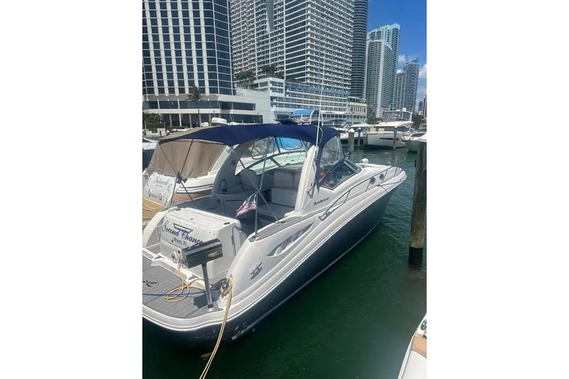  Yacht Photos Pics 2006 Sea Ray 340 Sundancer docked in a marina with city skyline.