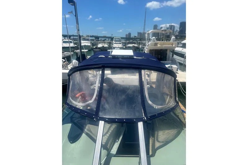  Yacht Photos Pics 2006 Sea Ray 340 Sundancer docked at marina under clear blue sky.