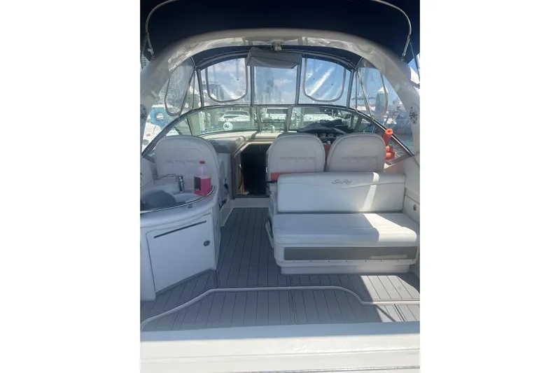  Yacht Photos Pics 2006 Sea Ray 340 Sundancer interior with seating and helm, featuring sleek design and comfort.