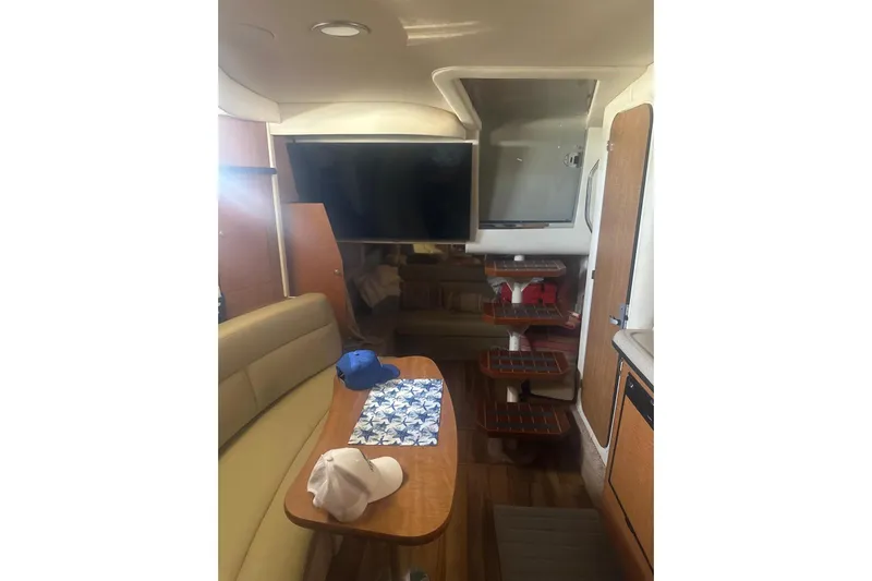  Yacht Photos Pics Interior of 2006 Sea Ray 340 Sundancer yacht with seating, table, and steps.
