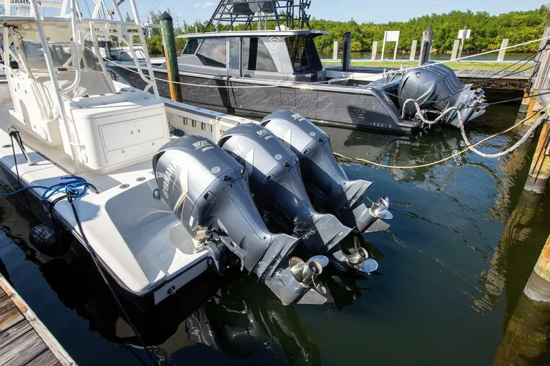 Evil Tequila Yacht Photos Pics 2015 Yellowfin 39 Offshore boat with triple outboard engines docked at marina.
