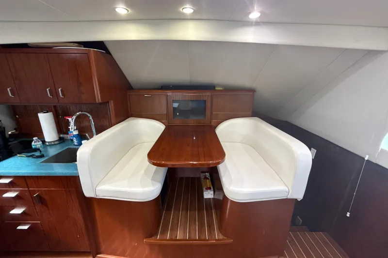 Sweet Melissa Yacht Photos Pics Luxurious 1992 Ocean Yachts 48 Super Sport interior with elegant dining area and wooden cabinetry.