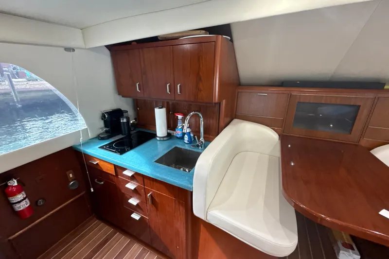 Sweet Melissa Yacht Photos Pics Interior of 1992 Ocean Yachts 48 Super Sport with modern kitchen and seating area.