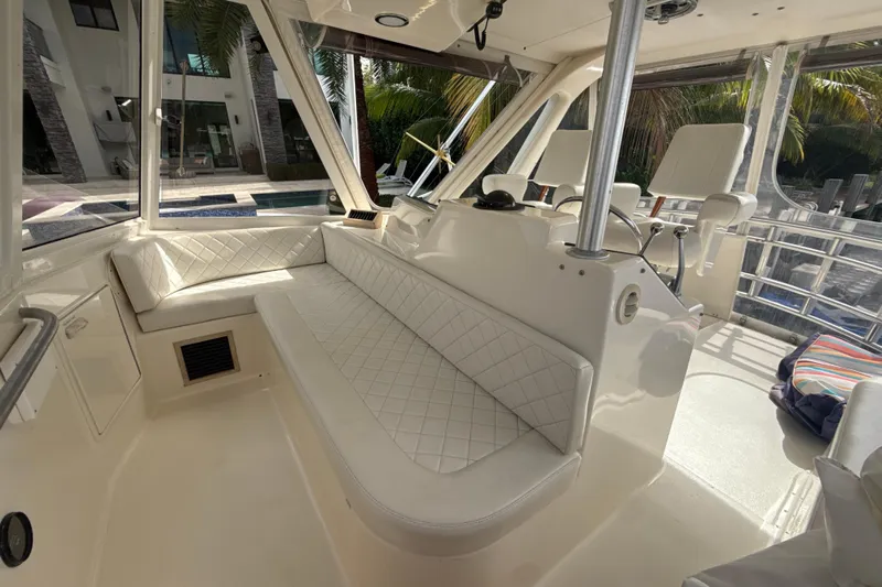 Sweet Melissa Yacht Photos Pics Interior of 1992 Ocean Yachts 48 Super Sport with white seating and helm area.