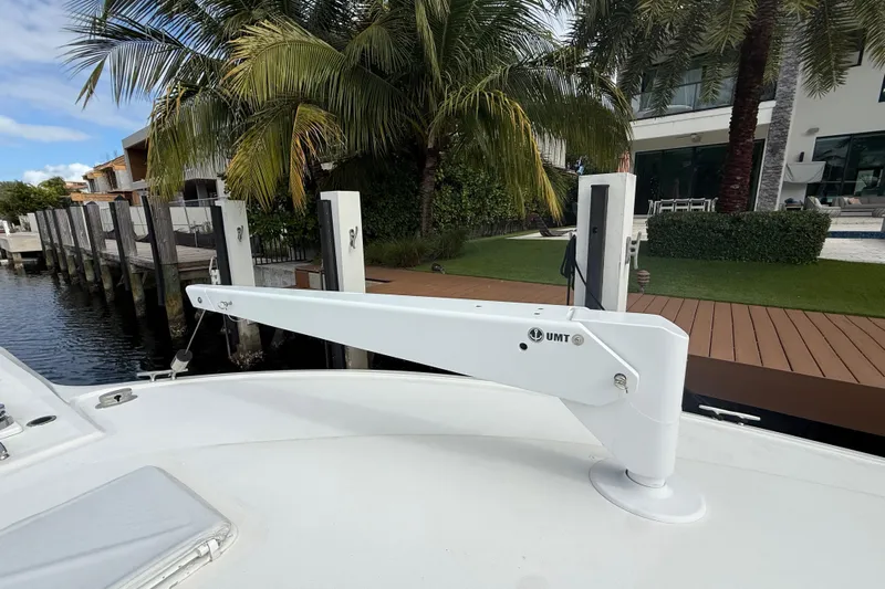 Sweet Melissa Yacht Photos Pics 1992 Ocean Yachts 48 Super Sport docked, featuring a UMT davit arm, surrounded by lush greenery.