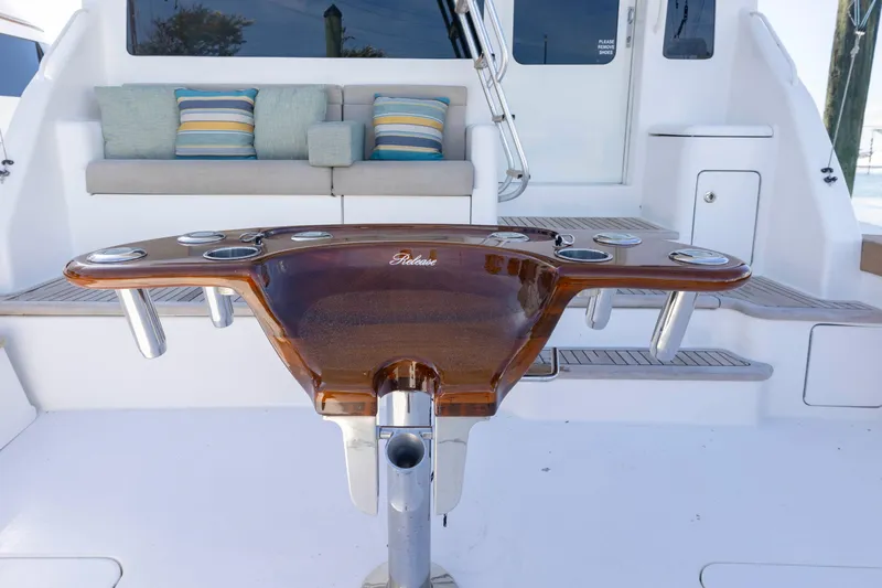 Wrangler Yacht Photos Pics 2008 Ocean Yachts 54 Super Sport cockpit with polished wood table and cushioned seating.