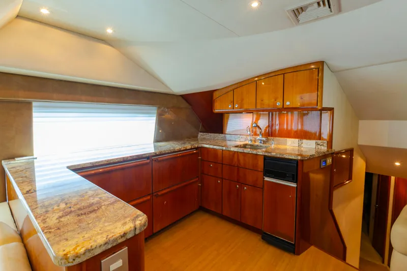 Wrangler Yacht Photos Pics Luxurious kitchen interior of 2008 Ocean Yachts 54 Super Sport with wood cabinetry and granite countertops.