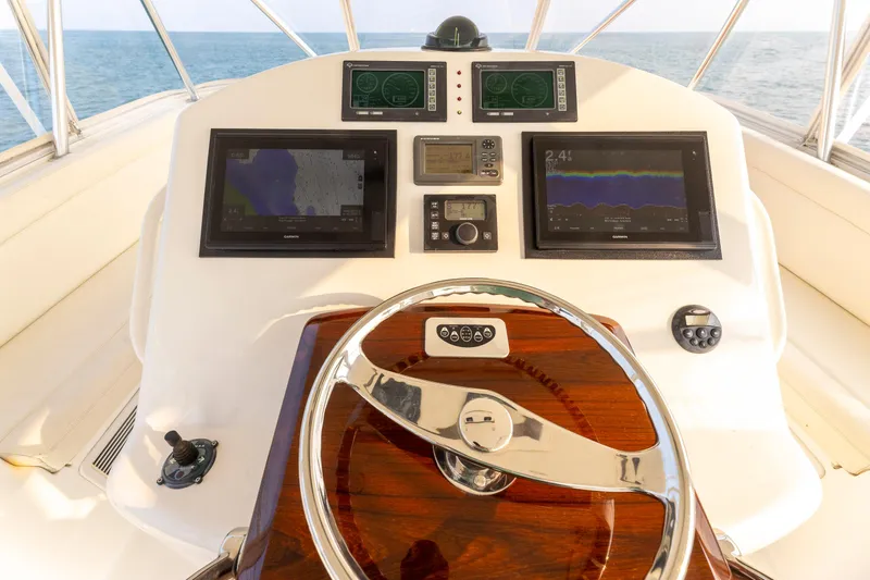 Wrangler Yacht Photos Pics Helm of 2008 Ocean Yachts 54 Super Sport with navigation displays and wooden steering wheel.