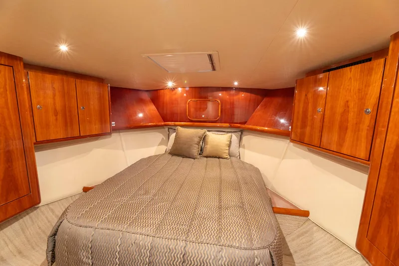 Wrangler Yacht Photos Pics Luxurious cabin interior of 2008 Ocean Yachts 54 Super Sport with wood cabinetry and cozy bedding.