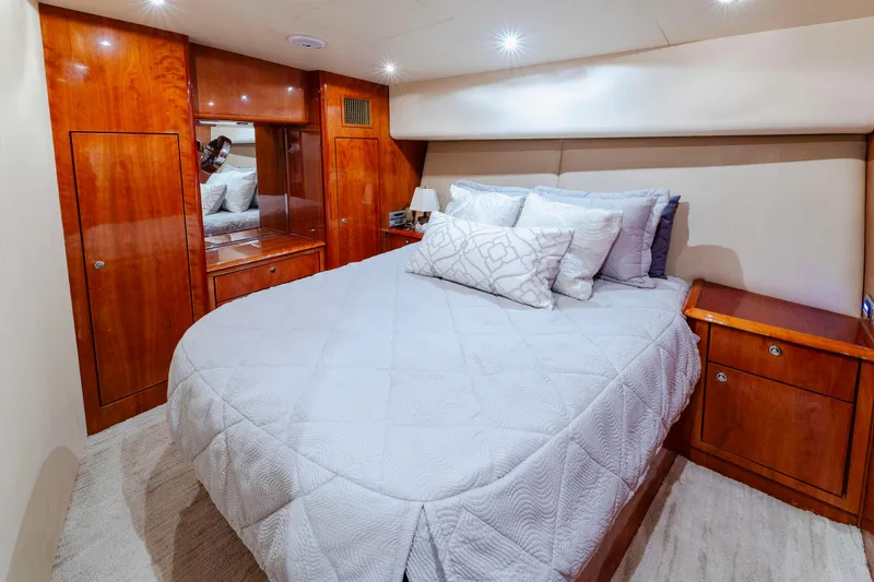 Wrangler Yacht Photos Pics Luxurious bedroom interior of 2008 Ocean Yachts 54 Super Sport with elegant wood finishes.