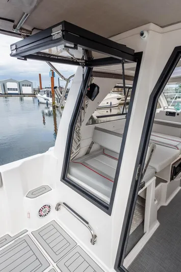  Yacht Photos Pics 2025 Solara S-250 Coupe interior with open door, dockside view.