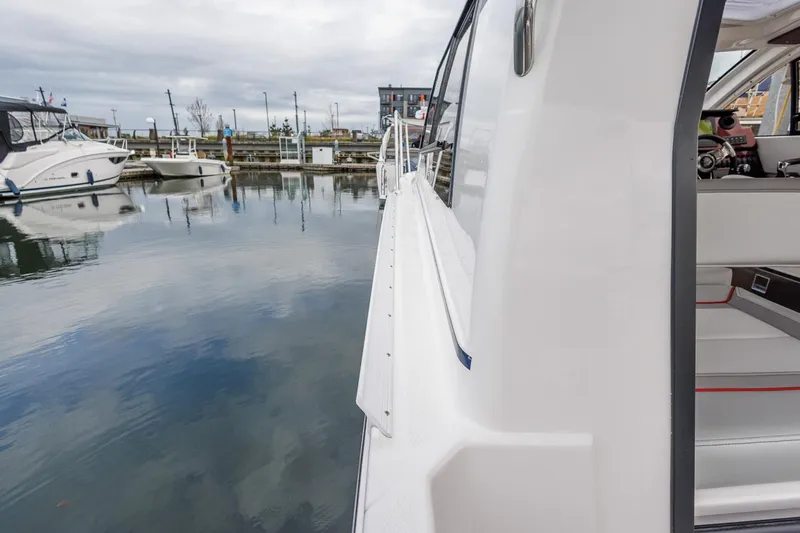  Yacht Photos Pics 2025 Solara S-250 Coupe docked at marina, side view.