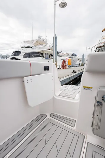  Yacht Photos Pics 2025 Solara S-250 Coupe boat interior at marina, featuring sleek design and modern amenities.
