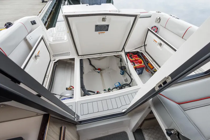  Yacht Photos Pics 2025 Solara S-250 Coupe boat interior with open storage compartments and visible wiring.