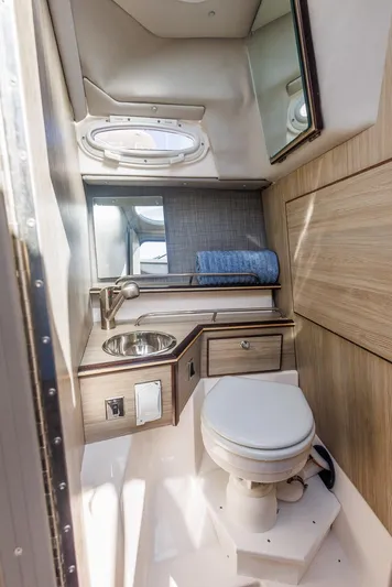  Yacht Photos Pics 2025 Solara S-250 Coupe bathroom with modern fixtures and wood accents.