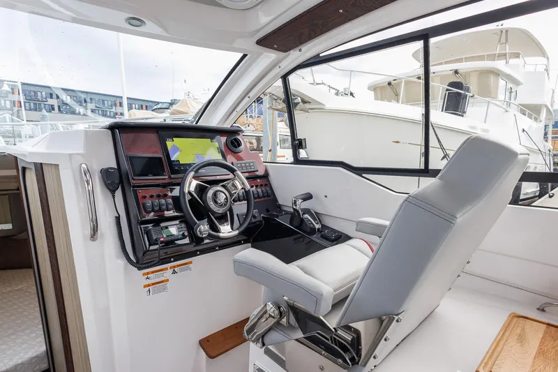  Yacht Photos Pics Interior of 2025 Solara S-250 Coupe boat with modern steering and navigation system.