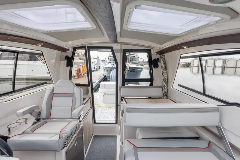  Yacht Photos Pics Interior of 2025 Solara S-250 Coupe boat, featuring modern seating and panoramic windows.