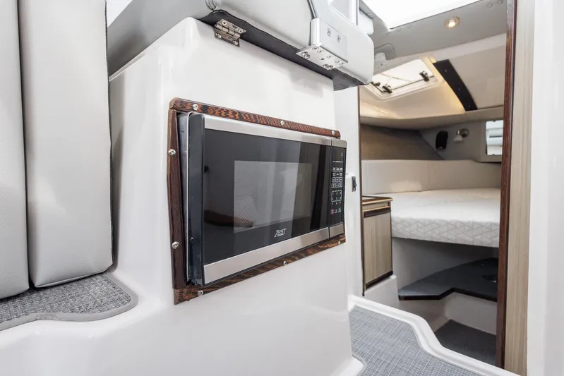  Yacht Photos Pics Interior of 2025 Solara S-250 Coupe with microwave and cozy sleeping area.